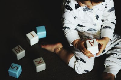 Close-up of young boy playing with blocks