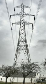Low angle view of electricity pylon against sky