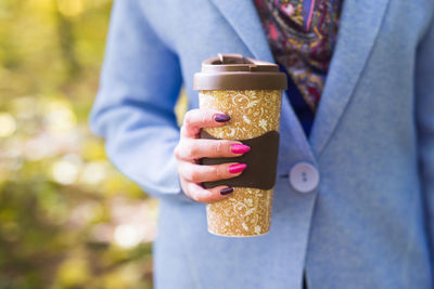 Midsection of woman holding ice cream