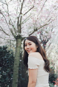 Portrait of a smiling young woman standing outdoors