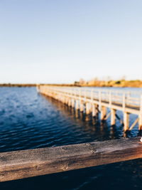 Pier over sea against clear sky