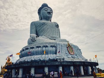 Low angle view of statue against cloudy sky