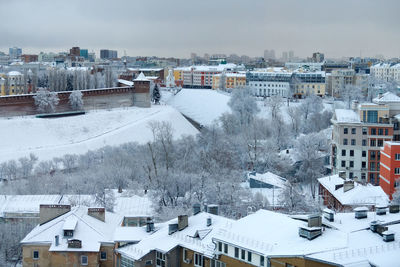 High angle view of snow covered houses in city