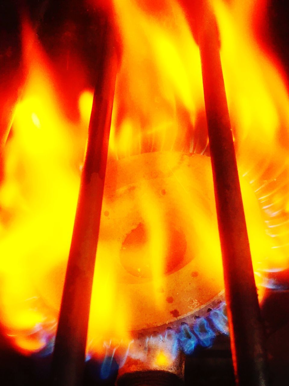 CLOSE-UP OF BONFIRE AGAINST ORANGE SKY