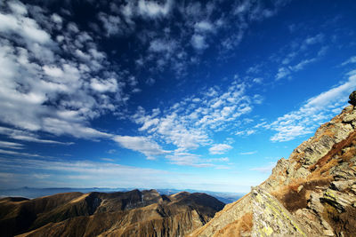 Scenic view of rocky mountains against blue sky