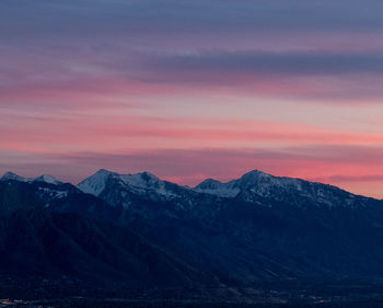 Scenic view of snowcapped mountains against sky during sunset