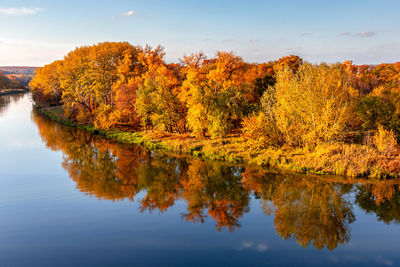 Autumn landscape.  multicolored autumn trees in the sun on the river bank.