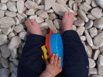 Low section of baby on stones