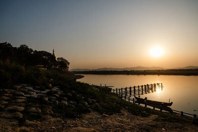 Scenic view of river in bagan against sky during sunset