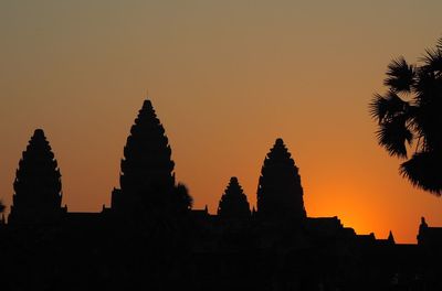 Silhouette temple against sky during sunset