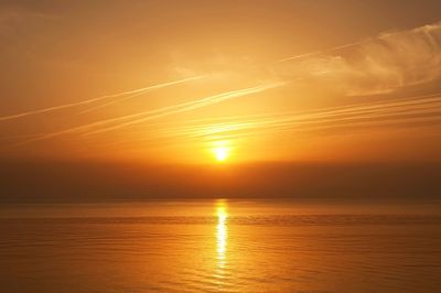 Scenic view of sea against romantic sky at sunset