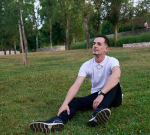 Portrait of young man standing on field