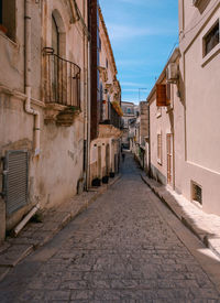 Alley in the historic center of scicli with man walking