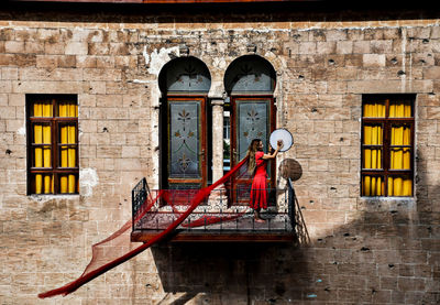 Rear view of woman standing in building