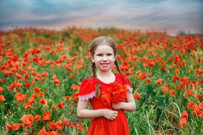 Portrait of smiling girl standing on field