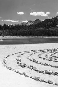 Distant lone swimmer bathes in a tranquil mountain lake