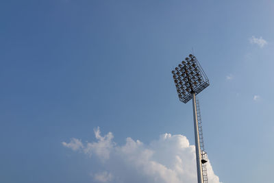 Low angle view of floodlight against blue sky