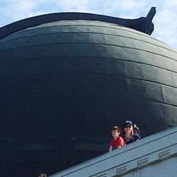 Low angle view of people walking on building against sky