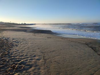 Scenic view of beach against clear sky