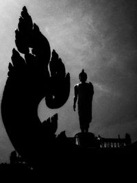 Low angle view of silhouette statue against sky at dusk
