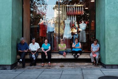 Rear view of people sitting on the floor