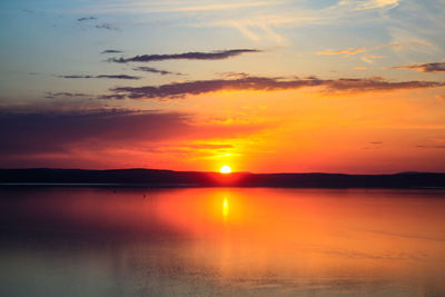 Scenic view of lake against romantic sky at sunset