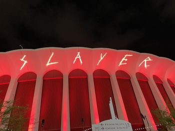 Low angle view of illuminated building against sky at night