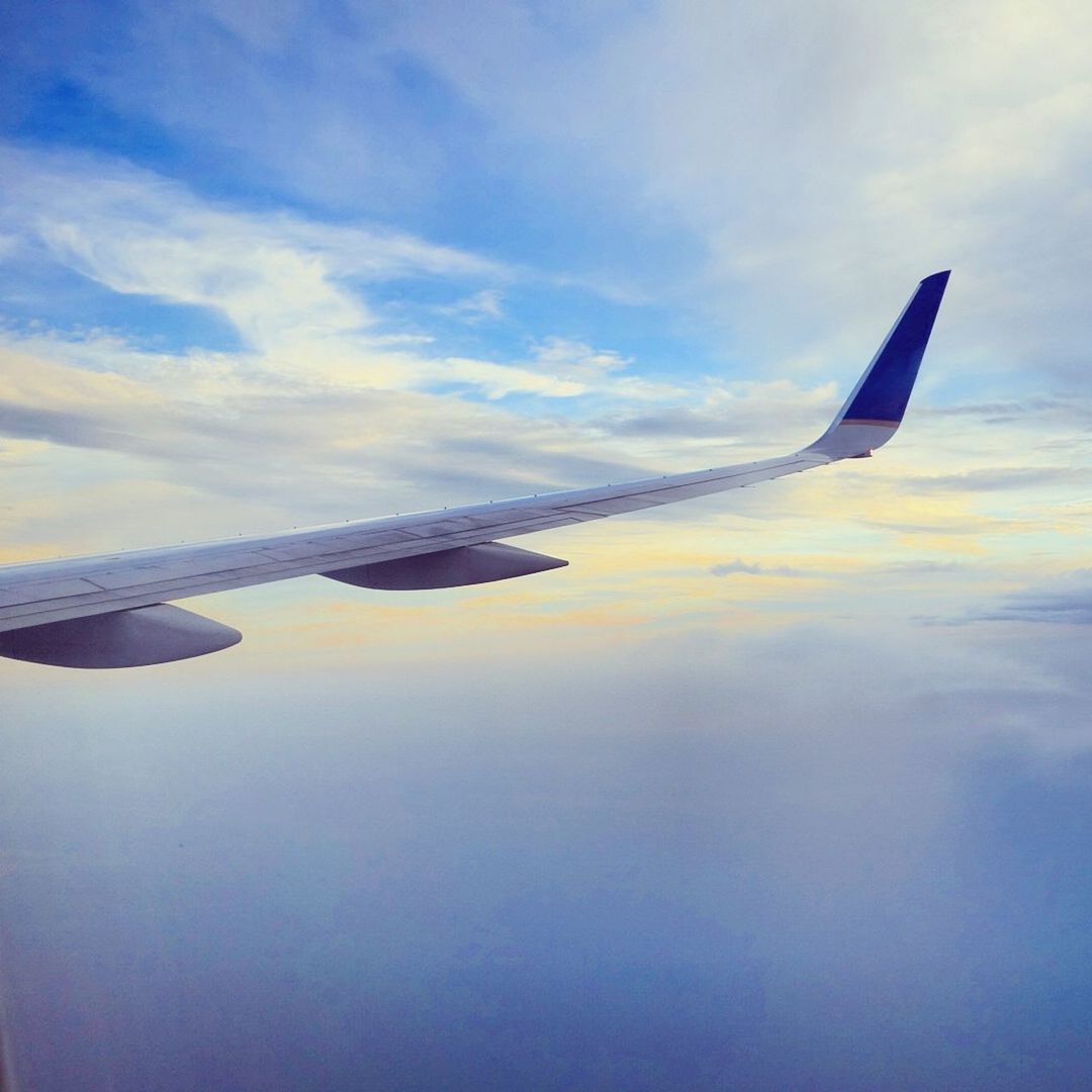 transportation, airplane, flying, mode of transport, aircraft wing, air vehicle, sky, part of, cropped, travel, aerial view, cloud - sky, mid-air, scenics, beauty in nature, nature, cloud, on the move, journey, tranquil scene