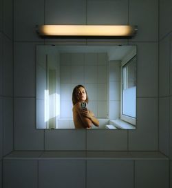 Woman sitting in bathroom