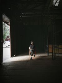 Woman sitting in chair in darkroom