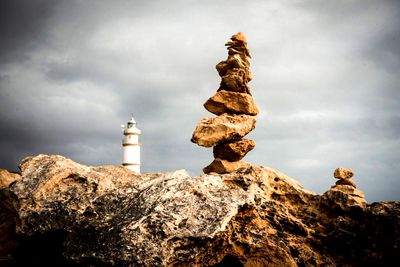 Low angle view of rocks on rock against sky