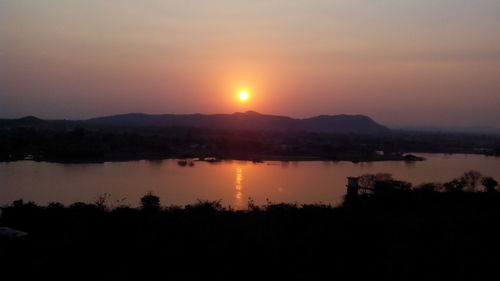 Scenic view of lake at sunset