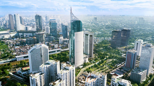 High angle view of modern buildings in city against sky