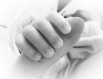 Close-up of hands holding baby hand
