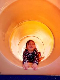 Full length of happy girl playing in playground