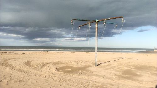 Scenic view of wind turbines on beach