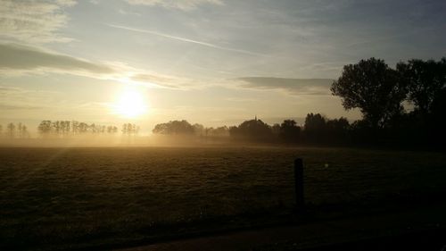 Scenic view of field against sky during sunset