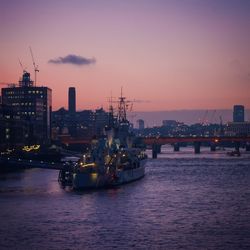 River with buildings in background at sunset