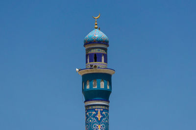 Low angle view of temple against clear blue sky