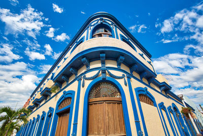 Low angle view of building against cloudy sky