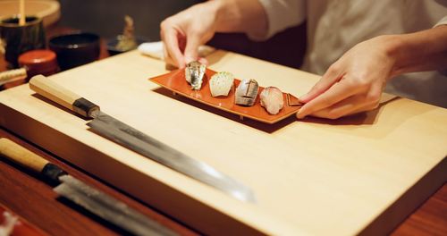 Cropped hands of man working on table