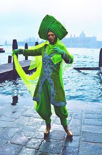 Full length of woman standing in water