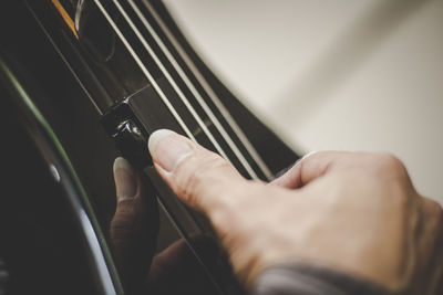 Midsection of man playing guitar