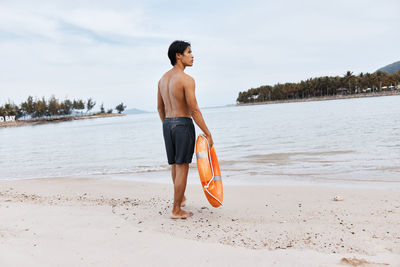 Full length of woman standing at beach