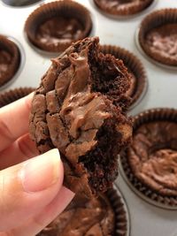 Close-up of hand holding chocolate cake