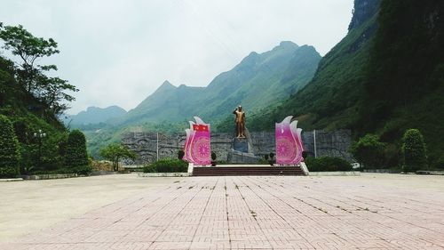 Rear view of people on mountain against sky