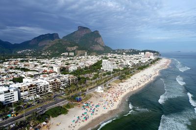 High angle view of buildings and sea against sky