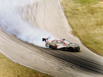 Racing car moving on dirt road