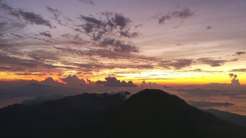 Scenic view of mountains against sky at sunset