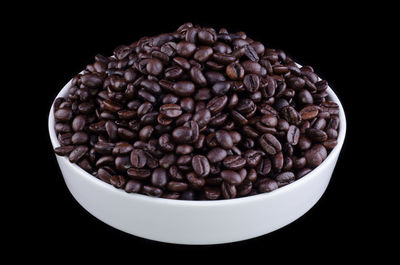 Close-up of coffee beans against black background